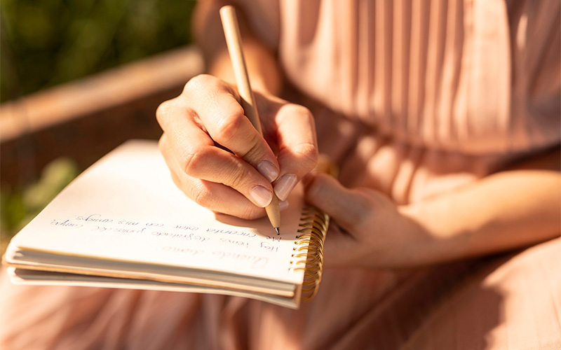 Woman jolting down her thoughts after meaningful self reflection
