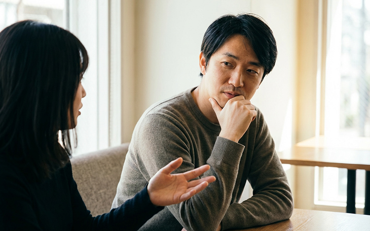 Person listening attentively to spouse showing emotional presence and active listening in conversation