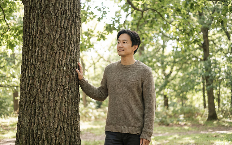Person standing peacefully in natural surroundings, representing growth, inner strength, and emotional resilience